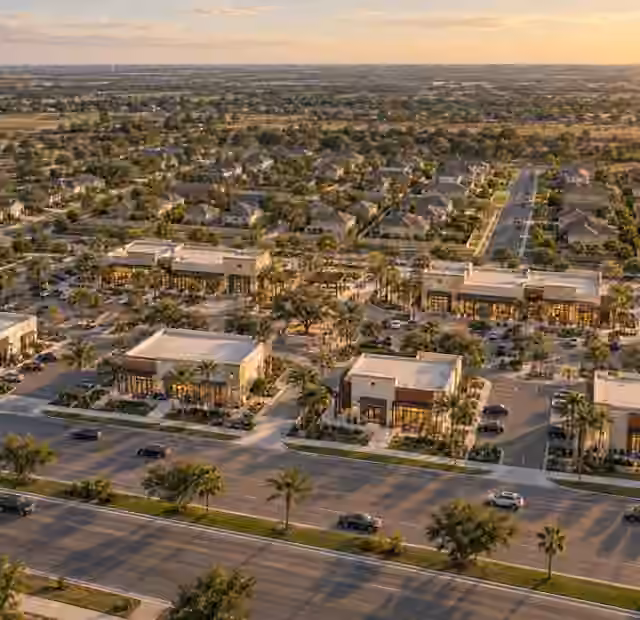 Conceptual mixed-use community with residential neighborhoods and commercial frontage, from the corporate profile.