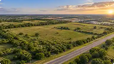Open land at sunset, illustrating the starting point of real estate development